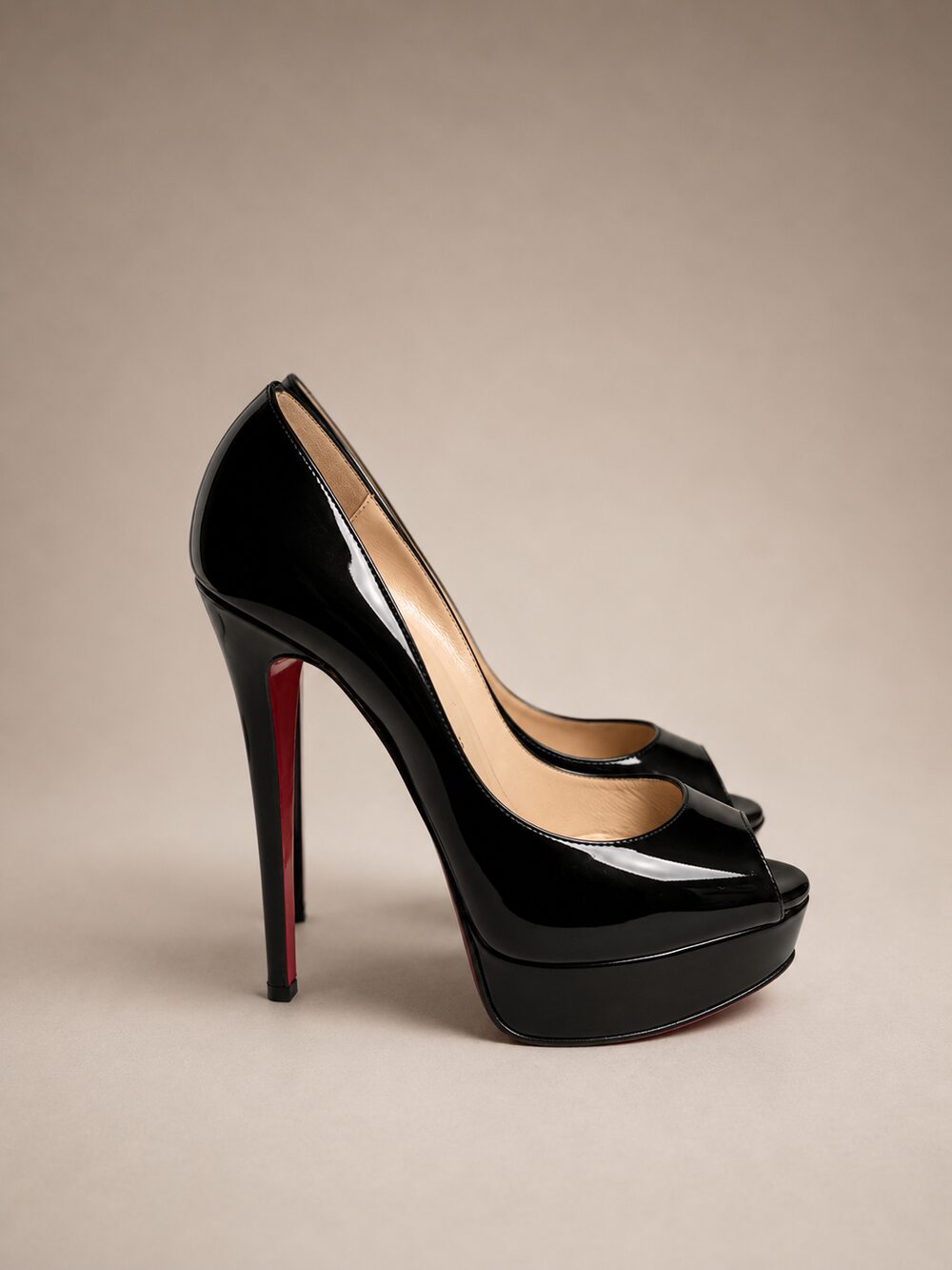 Black patent leather platform pumps with red soles